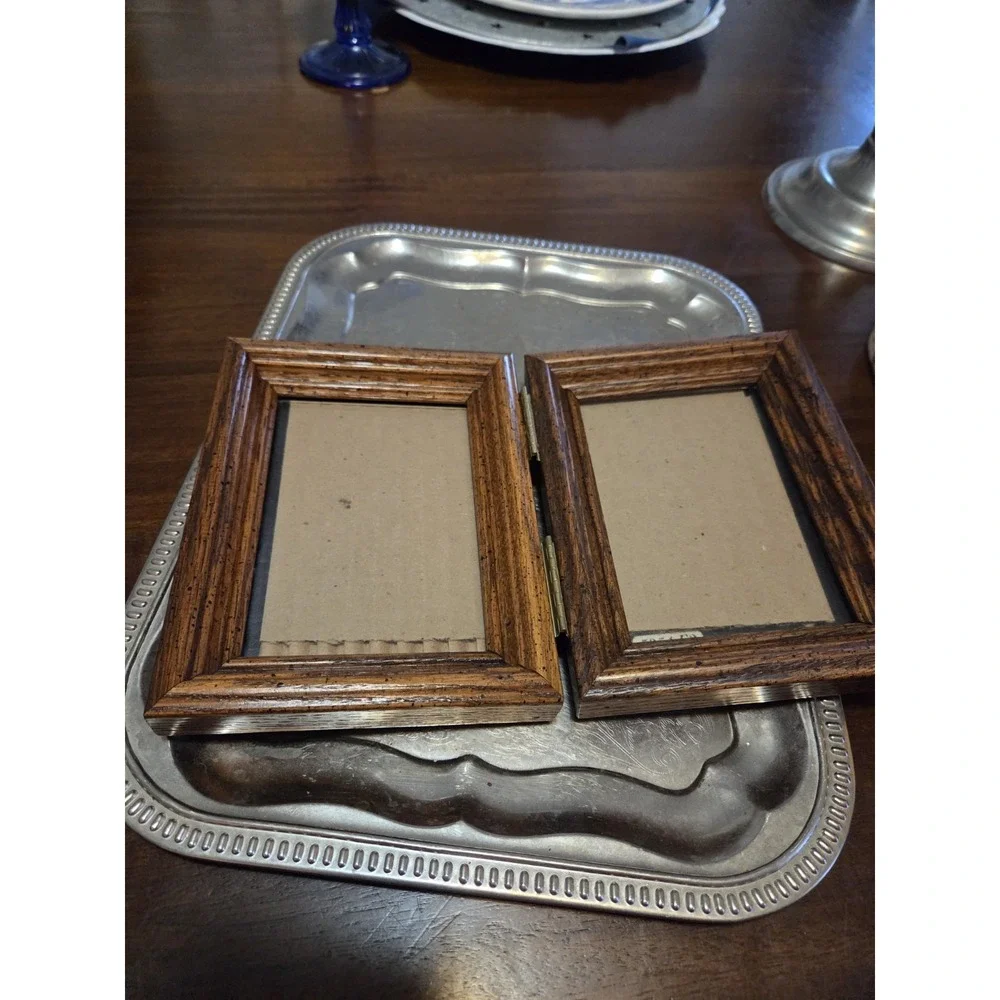 vintage bifold photo frame features a dark brown wood-grain finish and brass...